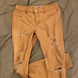 Mustard, ripped pants.